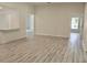 Open-concept living room with wood-look floors and bar seating at 1275 16Th St, Orange City, FL 32763