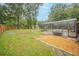 Expansive backyard featuring an enclosed swimming pool, a wooden fence, a shed, and a gravel area at 1500 Wyngate Dr, Deland, FL 32724