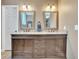 Bathroom vanity with granite countertop, dual sinks, and decorative mirrors at 1500 Wyngate Dr, Deland, FL 32724