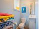 Cozy half bath features a small sink, toilet, and bright blue walls at 1500 Wyngate Dr, Deland, FL 32724