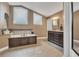 Large bathroom featuring a double sink vanity, and separate bathtub with wood trim at 1500 Wyngate Dr, Deland, FL 32724