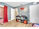 A simple room features wood look floors, red accents, and simple closet space at 1500 Wyngate Dr, Deland, FL 32724
