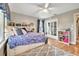 This cozy bedroom offers an open bookshelf, closet space, and a ceiling fan at 1500 Wyngate Dr, Deland, FL 32724