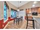 Charming dining area with wainscoting, a bay window, and views to outdoor living space at 1500 Wyngate Dr, Deland, FL 32724