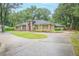 Charming single-Gathering home boasting mature trees and a circular driveway at 1500 Wyngate Dr, Deland, FL 32724