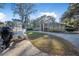 Charming single-story brick home with well-manicured landscaping and a circular driveway, plus a boat in the driveway at 1500 Wyngate Dr, Deland, FL 32724