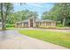 Well-maintained single-Gathering home featuring manicured landscaping and a circular driveway at 1500 Wyngate Dr, Deland, FL 32724