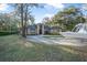 Beautiful single-Gathering home with a brick facade, circular driveway, and lush lawn at 1500 Wyngate Dr, Deland, FL 32724