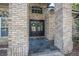 Close-up of the double front doors with brick pillars and a slate tile entryway at 1500 Wyngate Dr, Deland, FL 32724