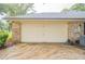 Attached two-car garage with a large, paved driveway in a residential neighborhood at 1500 Wyngate Dr, Deland, FL 32724
