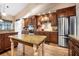 A kitchen featuring wood cabinets, stainless steel appliances, and a granite countertop table at 1500 Wyngate Dr, Deland, FL 32724