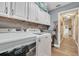 Laundry room with modern appliances, cabinets and wooden shelf at 1500 Wyngate Dr, Deland, FL 32724