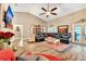 Spacious living room featuring vaulted ceilings, tile floors, and a comfortable leather sectional at 1500 Wyngate Dr, Deland, FL 32724