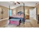 Inviting main bedroom with a four-poster bed, vaulted ceilings, and neutral decor at 1500 Wyngate Dr, Deland, FL 32724