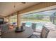 Inviting covered patio with a screened pool, spa and comfortable seating around a table at 1500 Wyngate Dr, Deland, FL 32724