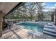 Entertain in this screened pool with a hot tub and outdoor dining space at 1500 Wyngate Dr, Deland, FL 32724