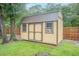 Backyard shed with double doors and windows, providing extra storage space at 1500 Wyngate Dr, Deland, FL 32724