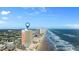 Panoramic aerial shot of the condo building along a sandy beachfront at 1900 N Atlantic Ave # 1603, Daytona Beach, FL 32118