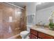 Well-lit bathroom with a glass-enclosed shower, granite vanity, and updated fixtures at 1900 N Atlantic Ave # 1603, Daytona Beach, FL 32118
