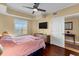 Relaxing bedroom with ceiling fan, hardwood floors, and a large window offering scenic views at 1900 N Atlantic Ave # 1603, Daytona Beach, FL 32118