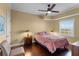 Comfortable bedroom with hardwood floors, ceiling fan, and natural light from the large window at 1900 N Atlantic Ave # 1603, Daytona Beach, FL 32118