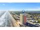 Sweeping aerial shot of a beachfront condo near the city skyline at 1900 N Atlantic Ave # 1603, Daytona Beach, FL 32118