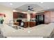 Open concept kitchen with granite counters, dark wood cabinets, and black appliances at 1900 N Atlantic Ave # 1603, Daytona Beach, FL 32118