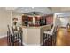 Kitchen with wooden cabinets, granite counters, bar seating and stainless steel appliances at 1900 N Atlantic Ave # 1603, Daytona Beach, FL 32118