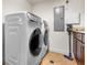 Well-equipped laundry room featuring a modern washer, dryer, storage cabinets and counter space at 1900 N Atlantic Ave # 1603, Daytona Beach, FL 32118