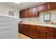 Practical laundry room with ample cabinet space, a utility sink, and modern appliances at 1900 N Atlantic Ave # 1603, Daytona Beach, FL 32118