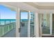 Bright balcony features patio furniture and sliding glass doors to the interior with ocean views at 1925 S Atlantic Ave # 201, Daytona Beach, FL 32118
