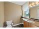 Cozy powder room with a granite vanity and decorative walls near a bright window at 1925 S Atlantic Ave # 201, Daytona Beach, FL 32118