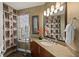 Well-lit bathroom with a granite countertop vanity, decorative mirror, and a shower at 1925 S Atlantic Ave # 201, Daytona Beach, FL 32118