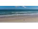 Expansive beach with ocean views and distant figures, perfect for relaxation and recreation at 1925 S Atlantic Ave # 201, Daytona Beach, FL 32118