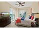 Bright bedroom featuring large windows with serene outside views and stylish furnishings at 1925 S Atlantic Ave # 201, Daytona Beach, FL 32118