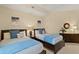 Neutral bedroom with two twin beds, soft blue accents, and minimalist decor at 1925 S Atlantic Ave # 201, Daytona Beach, FL 32118