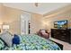 Relaxing bedroom with a tropical-themed bedspread, media center, and comfortable seating at 1925 S Atlantic Ave # 201, Daytona Beach, FL 32118