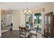 Elegant dining area with a glass table, balcony access, and a chandelier at 1925 S Atlantic Ave # 201, Daytona Beach, FL 32118