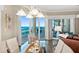 Bright dining room features a glass table and chairs with ocean views through sliding glass doors to the outdoor patio at 1925 S Atlantic Ave # 201, Daytona Beach, FL 32118