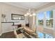 Bright dining room with a modern chandelier and a large window overlooking the outside at 1925 S Atlantic Ave # 201, Daytona Beach, FL 32118