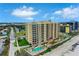 Aerial view of the condo building with a pool and ocean views at 1925 S Atlantic Ave # 201, Daytona Beach, FL 32118