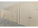 Hallway with multiple storage areas and patterned carpet flooring at 1925 S Atlantic Ave # 201, Daytona Beach, FL 32118