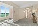 Elegant hallway with patterned carpet, stylish lighting, and a view of the outdoors at 1925 S Atlantic Ave # 201, Daytona Beach, FL 32118