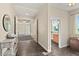 Open hallway with tile flooring, decorative table and access to other rooms at 1925 S Atlantic Ave # 201, Daytona Beach, FL 32118