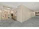 Well-lit hallway with patterned carpet, neutral walls, and recessed lighting at 1925 S Atlantic Ave # 201, Daytona Beach, FL 32118