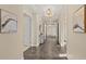 Inviting hallway with tiled floors, decorative lighting, and neutral wall colors at 1925 S Atlantic Ave # 201, Daytona Beach, FL 32118