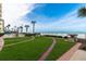Lush green lawn with manicured landscaping, walkways, and ocean views for outdoor enjoyment at 1925 S Atlantic Ave # 201, Daytona Beach, FL 32118