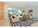 Stylish living room with a mirrored wall, elegant furnishings, and a contemporary rug at 1925 S Atlantic Ave # 201, Daytona Beach, FL 32118