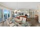 Bright dining room features a glass table and chairs next to an open-concept living room with ocean views at 1925 S Atlantic Ave # 201, Daytona Beach, FL 32118