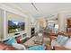 Inviting living room with a cozy fireplace and views into the kitchen and dining areas at 1925 S Atlantic Ave # 201, Daytona Beach, FL 32118